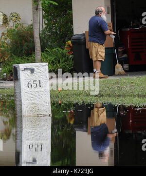 Altamonte Springs, United States. 14th Sep, 2017. September 14, 2017- Altamonte Springs, Florida, United States - A man and his mailbox are seen reflected in flood waters in the street in the Spring Oaks neighborhood of Altamonte Springs, Florida on September 14, 2017. Emergency workers used boats and trucks to rescue more than 50 residents on September 11, 2017 when water from the nearby Little Wekiva River swamped their homes in the wake of Hurricane Irma. Credit: Paul Hennessy/Alamy Live News Stock Photo