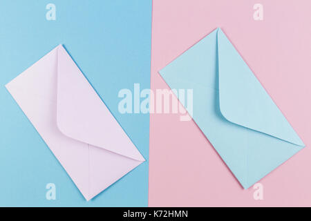 Pink and blue envelopes on colored pink and blue background. Top view. Stock Photo