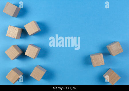 Wooden cubes on light blue background. Top view Stock Photo