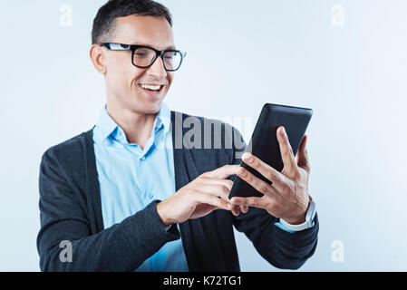 Joyful gentleman using digital tablet Stock Photo
