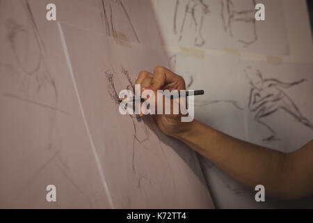 Artist drawing sketch on canvas in studio Stock Photo