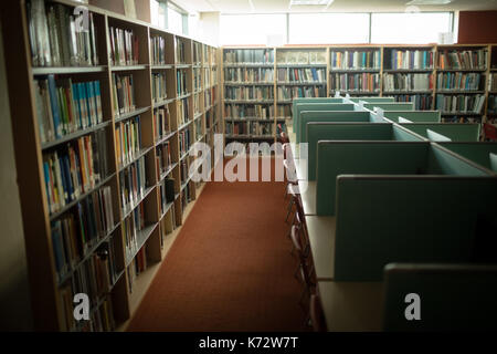 Empty desk and bookshelf in library room Stock Photo