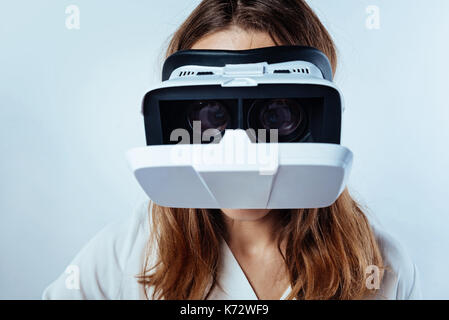 Close up of woman wearing VR headset Stock Photo