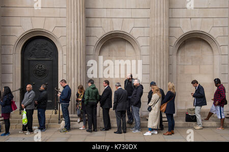People queue outside the Bank of England in London, to exchange money for the new ten pound note featuring Jane Austen. Stock Photo