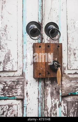 Vintage door locker on shabby door with key Stock Photo