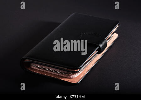 black wallet, isolated on a black background. Stock Photo
