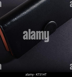 black wallet, isolated on a black background. Stock Photo