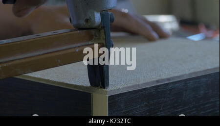 Fastening wooden frame using construction stapler isolated on white Stock  Photo by ©belchonock 41515109