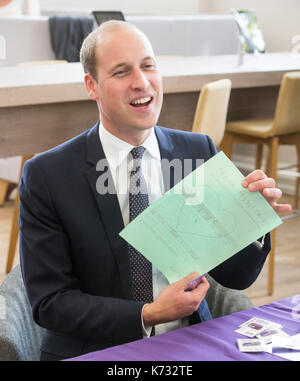 The Duke of Cambridge holds a piece of paper with 'Wills X' and a love heart written on it that was given to him during his visit to Mersey Care NHS Foundation Trust's Life Rooms in Walton - a community hub and home for the Recovery College. Stock Photo