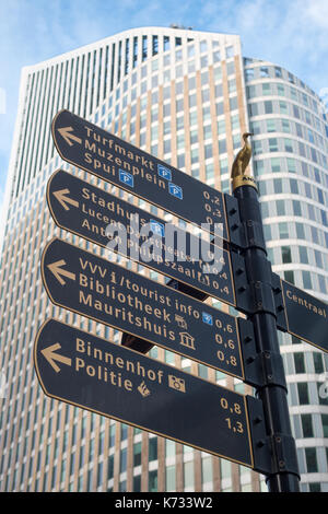 The Hague, the Netherlands - 26 November 2016: street direction sign in The Hague with tall building in background
