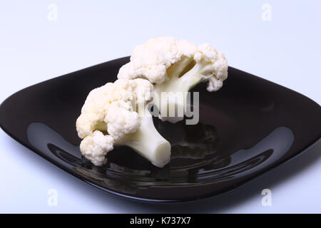 fresh cauliflower on black plate. Ready for cooking. Stock Photo