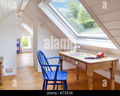 A bright and airy loft conversion, creating a great useable office space with a view of the garden Stock Photo