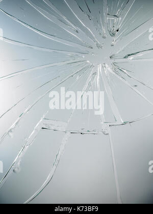 Cracks in the glass on the grey background Stock Photo