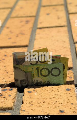 Australian one hundred dollar and fifty dollar note on brick wall. Stock Photo