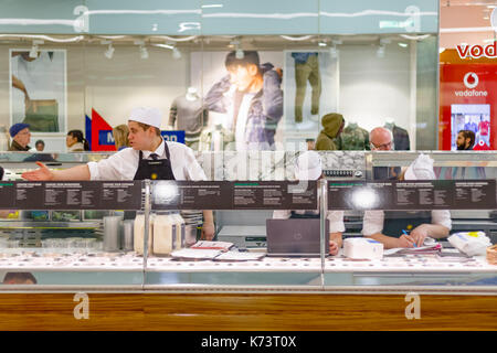 London, UK - September 15, 2017 - Staff working at a food bar in Canary Wharf Stock Photo