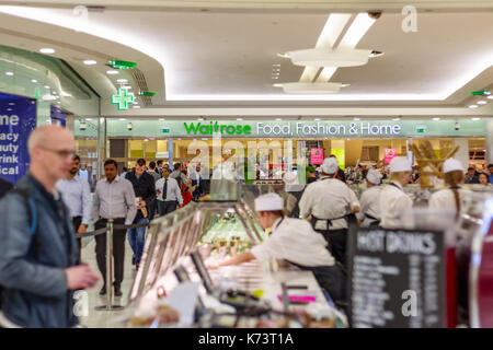 London, UK - September 15, 2017 - Waitrose Food, Fashion & Home, a chain of British supermarkets, in Canary Wharf with a busy crowd and food bars in t Stock Photo