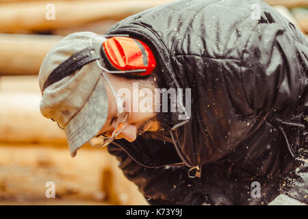 industry, building, technology and people concept - male builder in hardhat with walkie talkie or radio outdoors Stock Photo