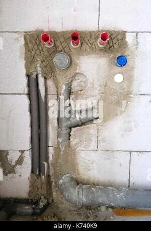 Installation of a water pipes and drainage tubes in new house construction. New water piping installation. Stock Photo