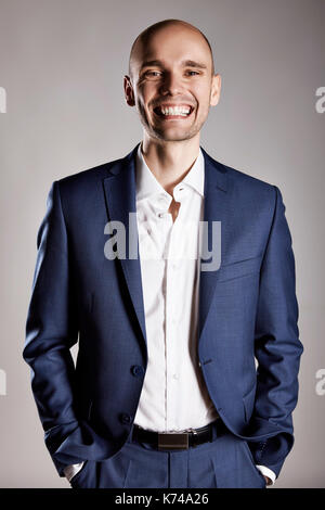 Young man in suit is making a funny face. Stock Photo