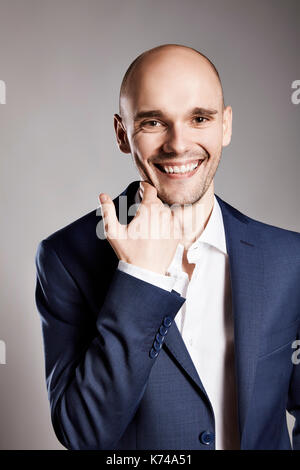 Portrait of handsome cheerful man stroking his chin. Stock Photo
