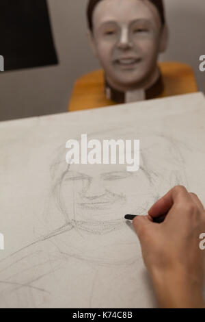 Hand of woman sketching on canvas in drawing class Stock Photo