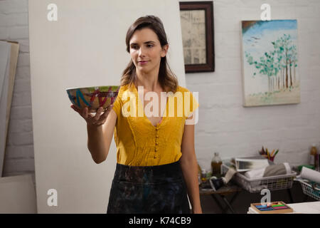 Woman looking at bowl in drawing class Stock Photo