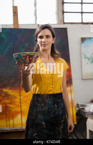 Woman looking at bowl in drawing class Stock Photo