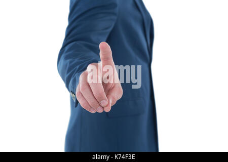 Mid section businessman using invisible imaginary interface while standing against white background Stock Photo