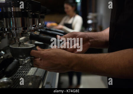 Mid section of waiter working at counter in restaurant Stock Photo