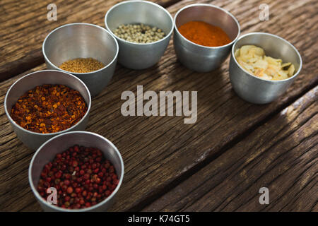 Various type of spices in bowl on a wooden table Stock Photo