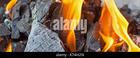 Fire and Coals Close Up. Burning Fire Bright Flames. Hot Charcoal Briquettes. Stock Photo