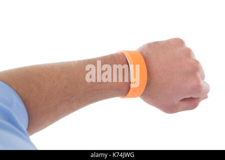 Cropped hand of businessman wearing orange smart watch against white background Stock Photo