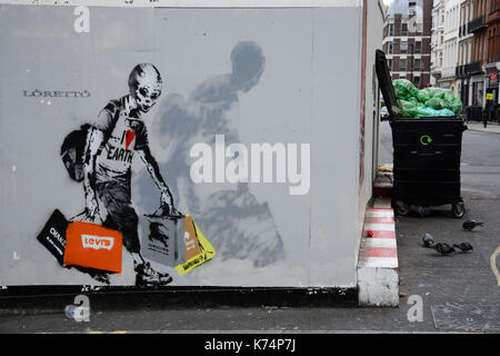 Grafitti on hoarding, Regent Street, London. Stock Photo