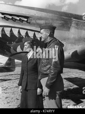 Maj Gen Claire L Chennault and an American Red Cross girl chat together in front of a North American P-51 Mustang at a Chinese 14th Air Force base, China, 12/22/1944. Stock Photo