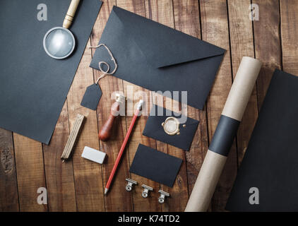 Blank black stationery set on wood table background. Template for branding ID. Top view. Stock Photo