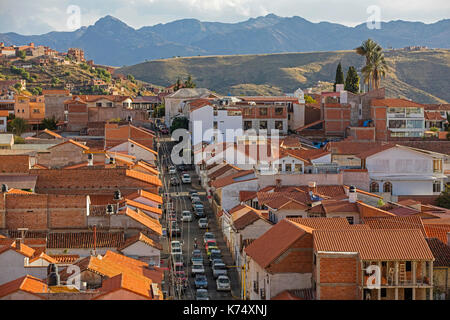 Aerial view over busy colonial street and rooftops in the white city of Sucre, constitutional capital of Bolivia in the Oropeza Province Stock Photo