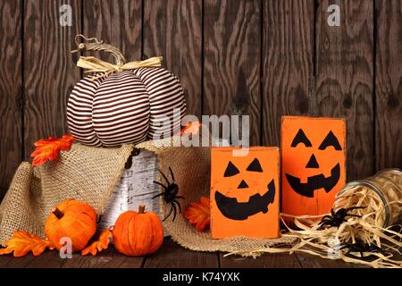 Rustic shabby chic Halloween decor against an old wood background Stock Photo