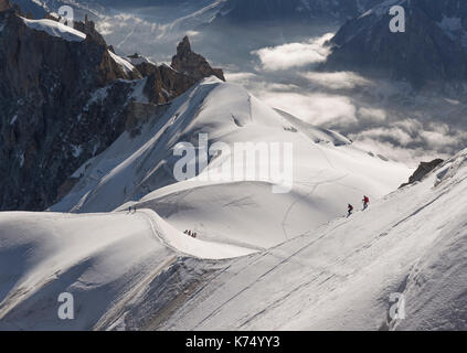 View from the Aiguille du Midi, 3842 m, Firngrat downhill to the Col du Plan, at the back Midi-Plan ridge with rock needle Stock Photo