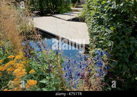Modern paving based on 'crazy paving' technique in the Watch This Space garden designed by Andy Sturgeon at RHS Hampton Court Palace Flower Show 2017. Stock Photo