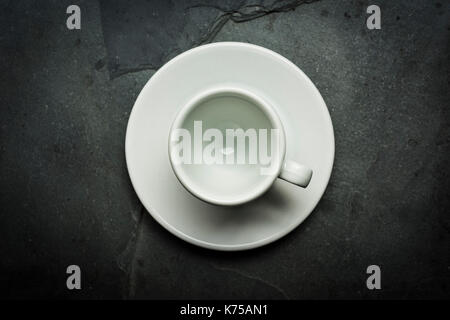 White ceramic cup of espresso coffee on a grey slate surface 14.09.2017 PHILLIP ROBERTS Stock Photo