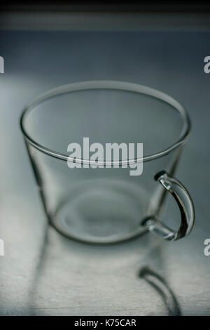 Empty glass coffee cup on a stainless steel surface 14.09.2017 PHILLIP ROBERTS Stock Photo