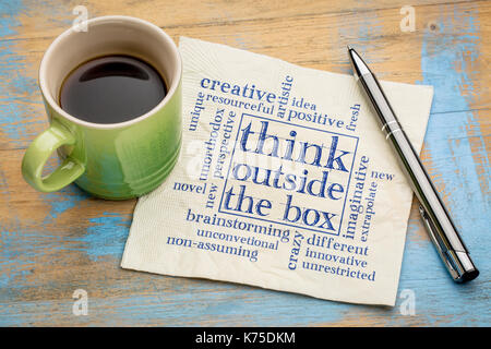 Think outside the box concept - word cloud on a napkin with a cup of coffee Stock Photo