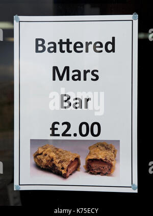 Sign advertising battered Mars bars, England UK Stock Photo