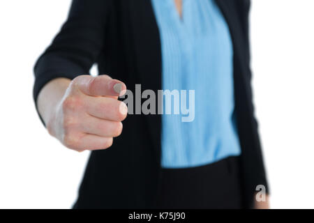 Mid section of businesswoman touching imaginary interface while standing against white background Stock Photo