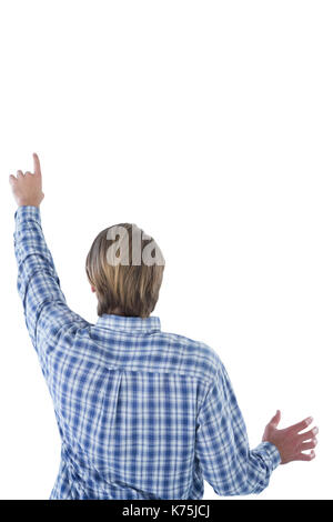 Rear view of businessman using imaginary interface against white background Stock Photo