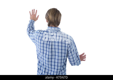 Rear view of businessman using imaginary screen against white background Stock Photo