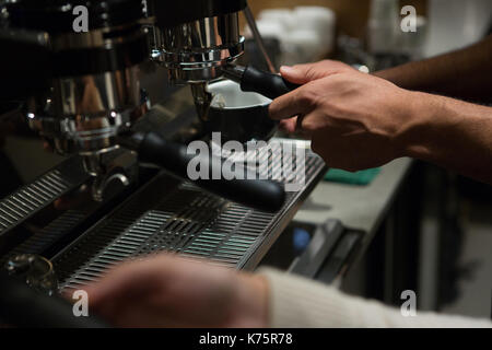 Waiter and waitress working at counter in restaurant Stock Photo