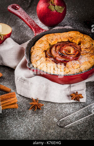 Traditional autumn baking, recipes for thanksgiving, Homemade wholegrain apple galette pie with organic apples and cinnamon, In iron cast pan, black s Stock Photo