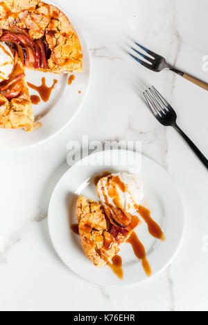 Traditional autumn baking, recipes for thanksgiving, Homemade wholegrain apple galette pie with organic apples and cinnamon, white marble table, copy  Stock Photo