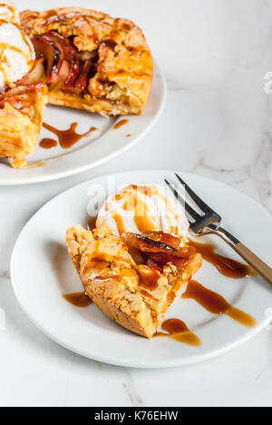 Traditional autumn baking, recipes for thanksgiving, Homemade wholegrain apple galette pie with organic apples and cinnamon, white marble table, copy  Stock Photo